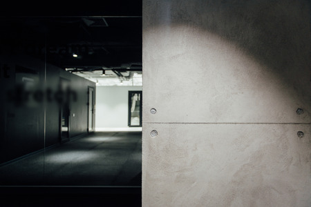 gray concrete wall in a dark roomの写真素材