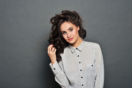 Beautiful woman with red lips and fly hairの写真素材