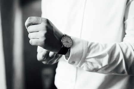 The man in the white shirt in the window wears watchesの写真素材