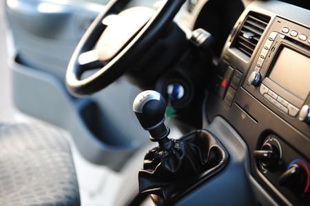 Modern luxury prestige car interior, dashboard, steering wheel. Black perforated leather interior....