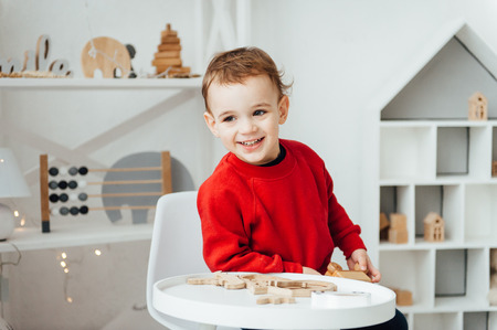 beautiful baby boy playing with toys and smilingの写真素材