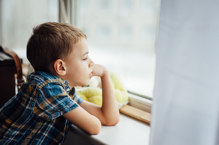 very cute and beautiful teenager sitting near a window.の写真素材