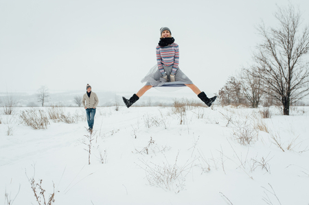 Happy Young Couple in Winter Park having fun.Family Outdoors. loveの写真素材