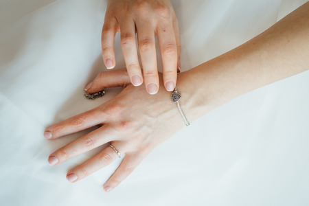 beautiful bride holding a necklace in her handsの写真素材