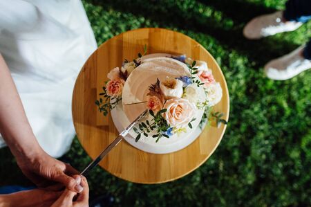 Happy bride and groom cut the cake. Evening ceremonyの写真素材