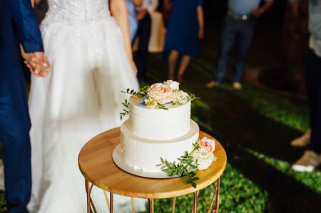 Happy bride and groom cut the cake. Evening ceremonyの写真素材