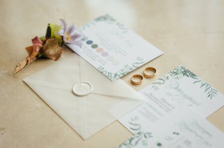 Wedding invitation card with the envelope, a ring in the jewel-box, satin ribbons on the wedding...