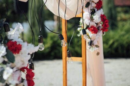 Decoration wedding arch with white and pink flowers on a green natural background.の写真素材
