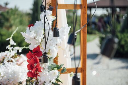 Decoration wedding arch with white and pink flowers on a green natural background.の写真素材
