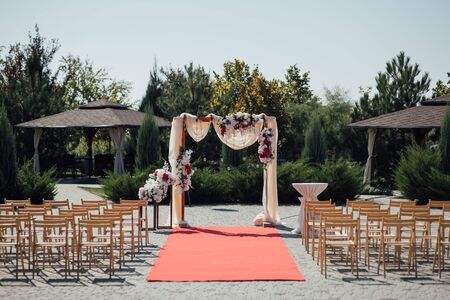 Decoration wedding arch with white and pink flowers on a green natural background.の写真素材