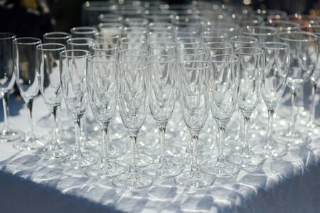 A row of empty champagne glasses on table. Banquet settingの写真素材