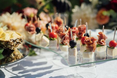 Delicious snacks on wedding reception table in luxury outdoor restaurantの写真素材