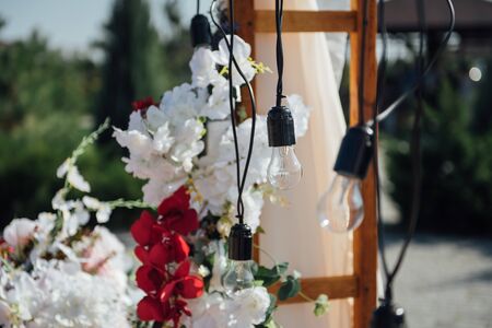 Decoration wedding arch with white and pink flowers on a green natural background.の写真素材