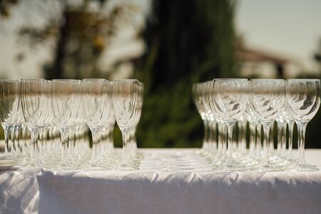 A row of empty champagne glasses on table. Banquet settingの写真素材