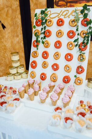 Beautiful multicolored decorated candy table baked sweet tasty cupcake cupcakes on a party.の写真素材