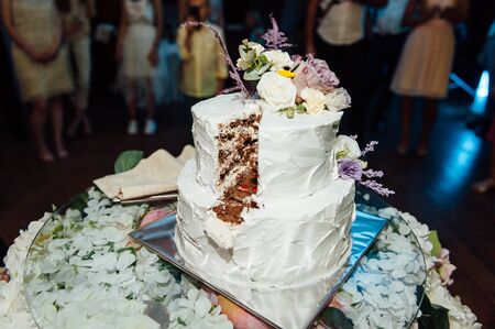 Happy bride and groom cut the cake. Evening ceremonyの写真素材