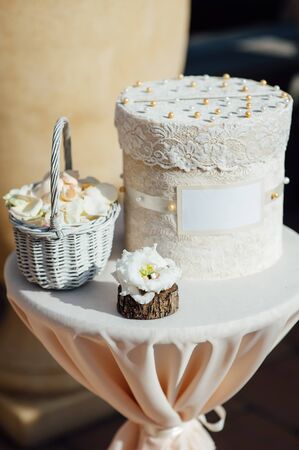 Two wedding rings with white flower in the backgroundの写真素材