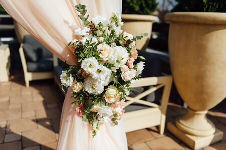 Arch for the wedding ceremony, decorated with cloth and flowersの写真素材