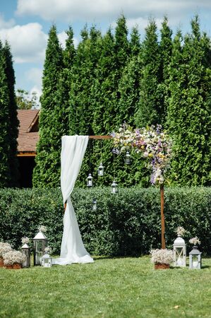 Arch for the wedding ceremony, decorated with cloth and flowersの写真素材