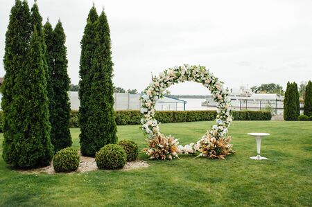 Arch for the wedding ceremony, decorated with cloth and flowersの写真素材