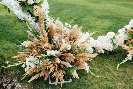 Arch for the wedding ceremony, decorated with cloth and flowersの写真素材