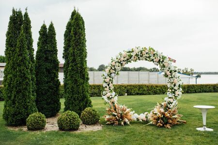 Arch for the wedding ceremony, decorated with cloth and flowersの写真素材