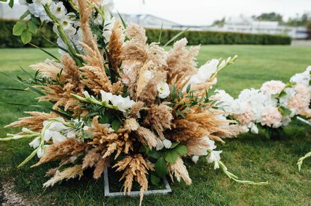 Arch for the wedding ceremony, decorated with cloth and flowersの写真素材