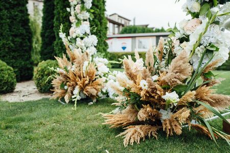 Arch for the wedding ceremony, decorated with cloth and flowersの写真素材