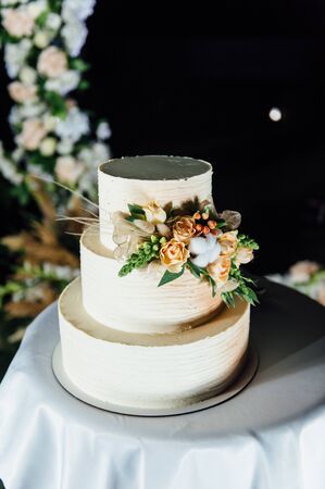 wedding cake three floors with fruit outside in the eveningの写真素材