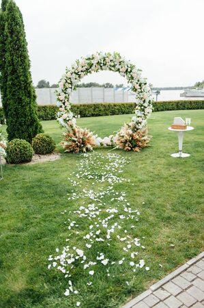 Arch for the wedding ceremony, decorated with cloth and flowersの写真素材