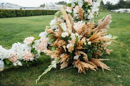 Arch for the wedding ceremony, decorated with cloth and flowersの写真素材