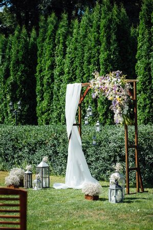 Arch for the wedding ceremony, decorated with cloth and flowersの写真素材