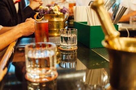 Group of friends having drinks whiskey at the night club after work .の写真素材