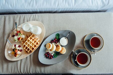 delicious breakfast for two on bed at the luxury hotel.の写真素材