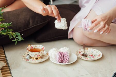 Young beautiful couple eating breakfast in bed.の写真素材