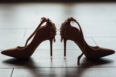 wedding rings on the bride shoes. Wedding. Decor. Bride shoes.の写真素材