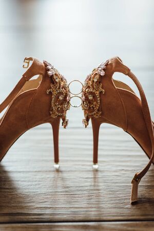 wedding rings on the bride shoes. Wedding. Decor. Bride shoes.の写真素材