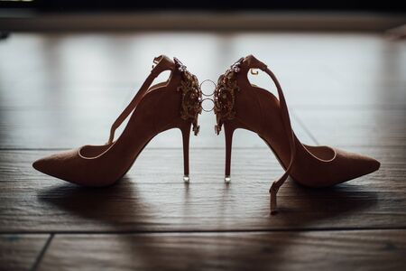 wedding rings on the bride shoes. Wedding. Decor. Bride shoes.の写真素材
