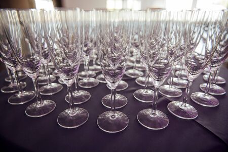 A row of empty champagne glasses on table. Banquet settingの写真素材