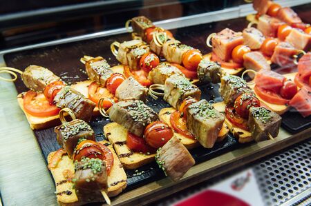 A wide variety of traditional tapas with seafood in Spain at the San Miguel marketの写真素材