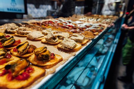 A wide variety of traditional tapas with seafood in Spain at the San Miguel marketの写真素材