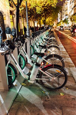 A charging station for rental electric bicycles for general use. Central street in Madrid. bikes can be rented using a smartphone.の写真素材
