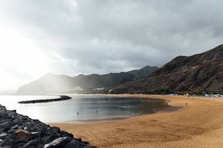 View from the height of the golden sand, palm trees, sun loungers. cloudy weatherの写真素材