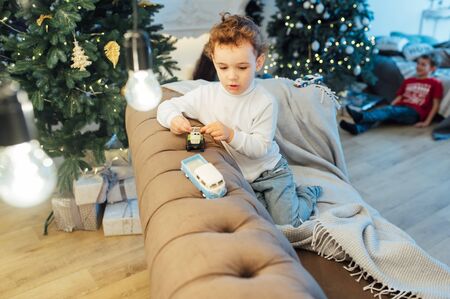beautiful baby boy playing with toys and smilingの写真素材
