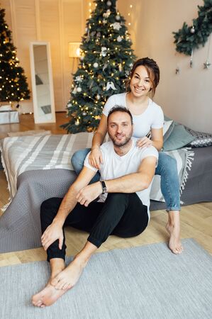 Romantic couple in love feeling happiness about their romance spending christmas eve together,の写真素材