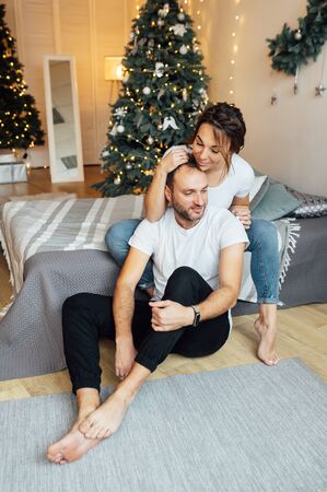 Romantic couple in love feeling happiness about their romance spending christmas eve together,の写真素材