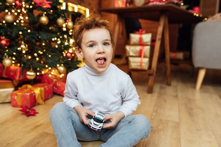beautiful baby boy playing with toys and smilingの写真素材