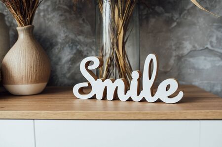 artifiacial flower in vase on top of wooden sideboard. studio shootの写真素材