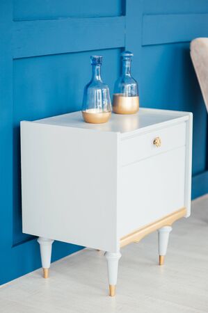 chic chest of drawers with home plants and decoration in a spacious room.の写真素材
