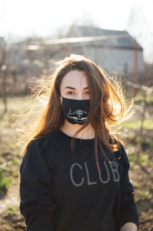 beautiful happy girl trying on a mask to protect against a dangerous virus. Concept of health and safety life, N1H1 coronavirus, virus protection, pandemic in chinaの写真素材